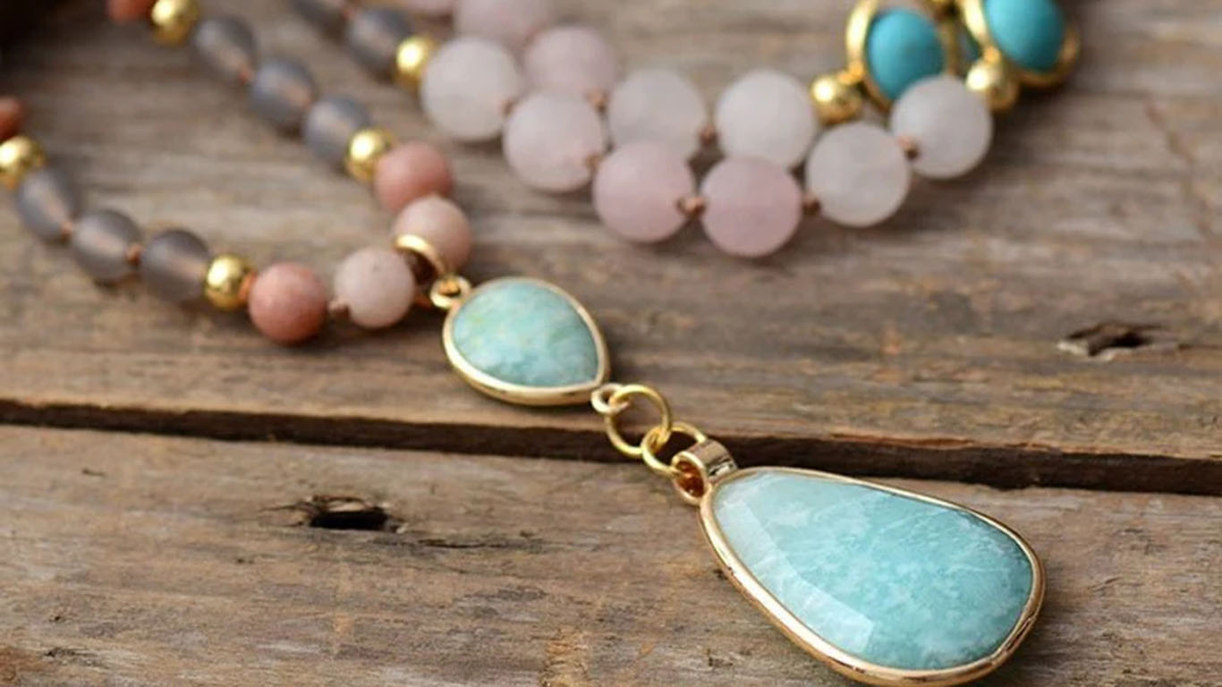 Beaded necklace with a pale blue teardrop pendant